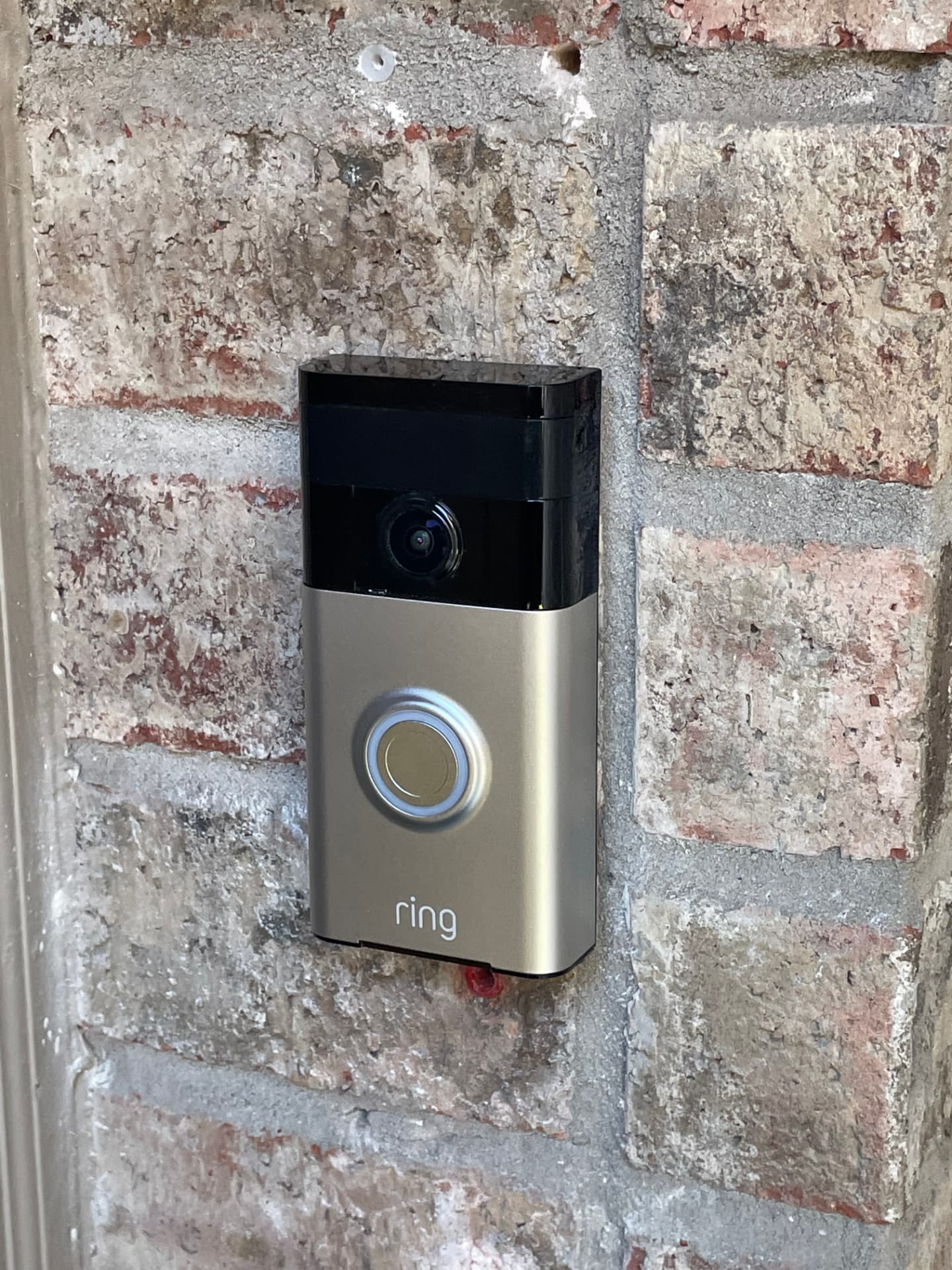 Video doorbell installed on a brick entryway